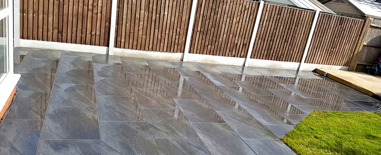 Grey sandstone circle paving slabs with charcoal edging