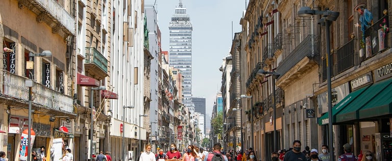 a city street scene with people walking down a street