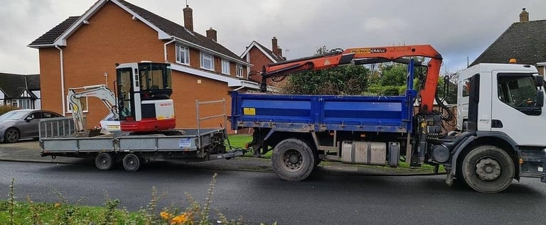 mini digger loaded on the back of a trailor in birmingham