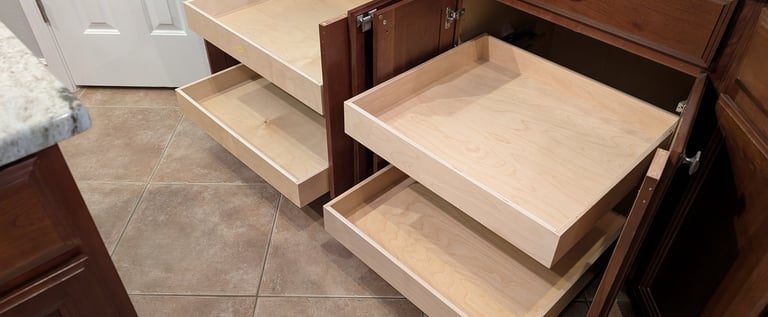 Four pull out shelves extending from two kitchen cabinets, showing excellent storage possibilities.