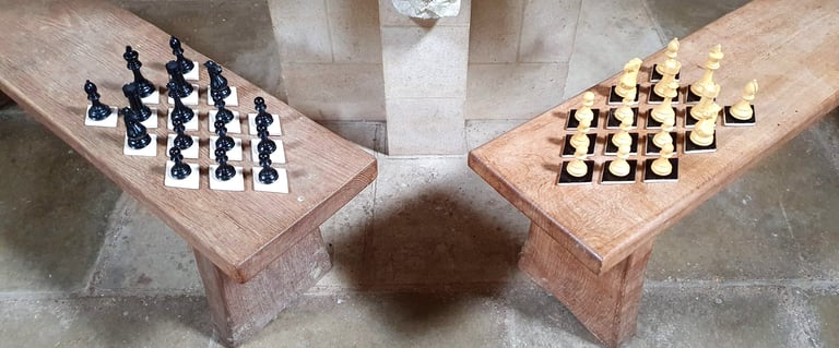 Thirty-two lozenge tiles, half black, half white, holding chess pieces