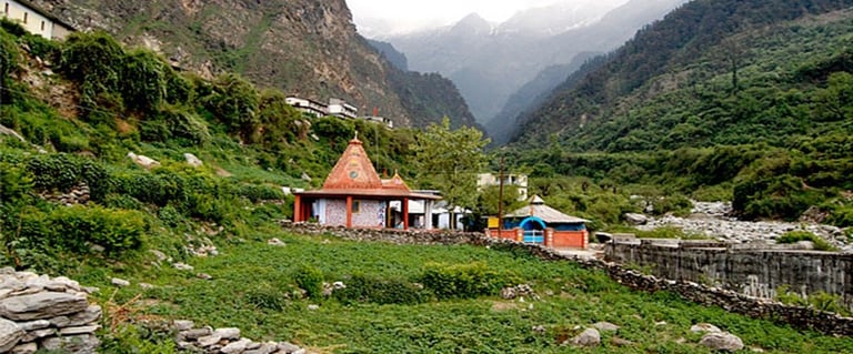 a small village in the mountains with a mountain in the background