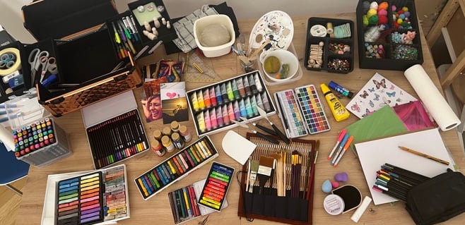 a table with a variety of art supplies and supplies