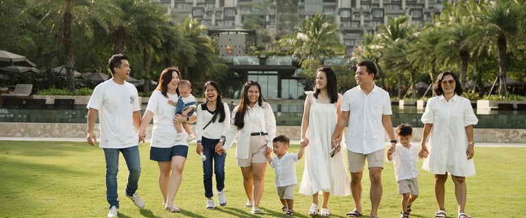 Large family walking together on the lawn at The Apurva Kempinski Nusa Dua Bali