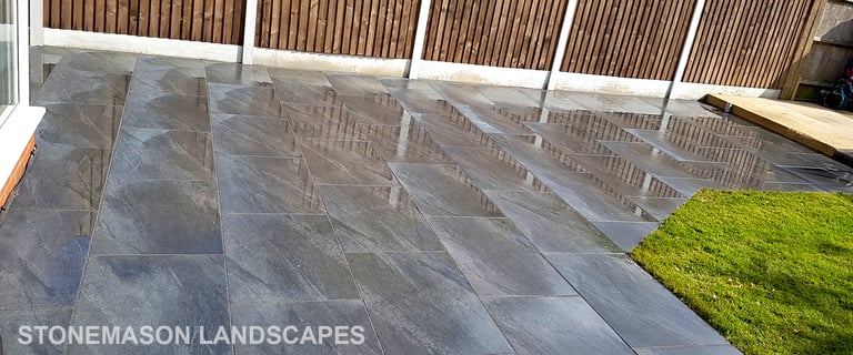Grey sandstone circle paving slabs with charcoal edging
