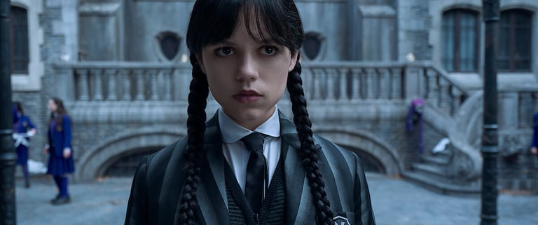 Jenna Ortega as Wednesday Addams in Season 2, wearing her signature braids and striped uniform, stan