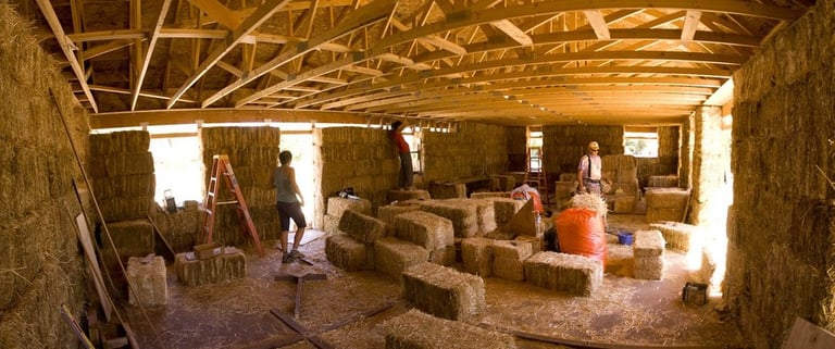 a group of people working on hay bale bale