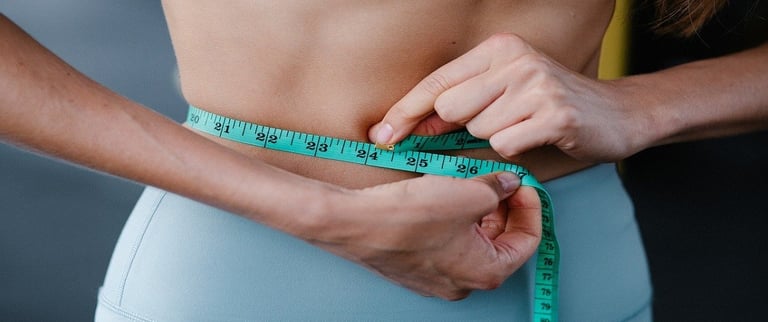 Measuring tape around woman's waist