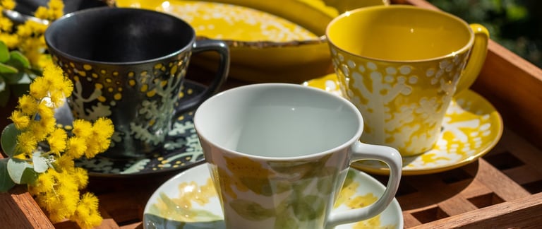 a tray with a tray of tea cups and a tray with a cup of coffee