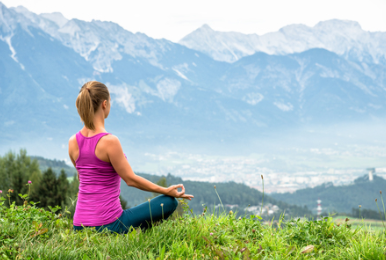 A woman meditating for mental and physical well-being.