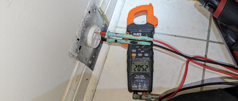 Digital Multimeter connected to power outlet