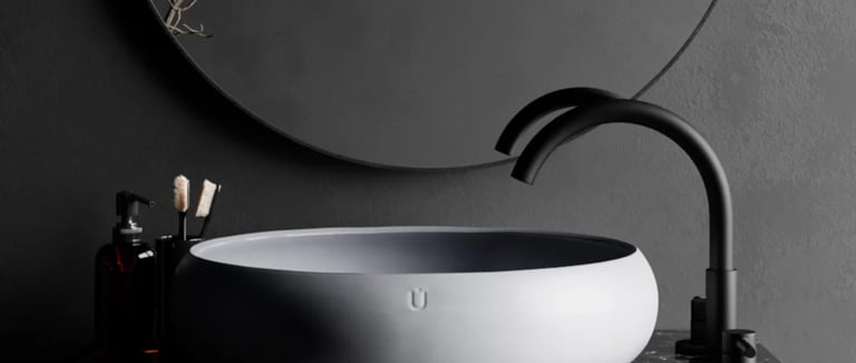 Cuba branca de design minimalista sobre bancada de pedra escura com torneira preta em banheiro