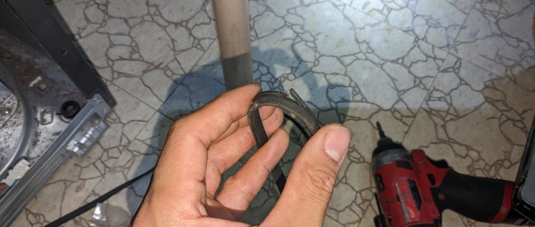 a technician holding a dryer belt