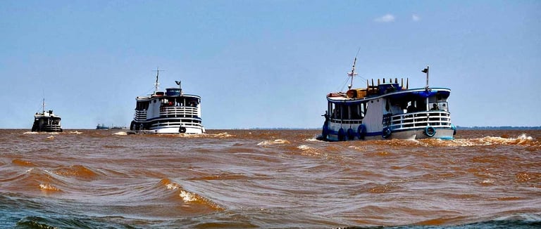 two boats are in the water near the shore