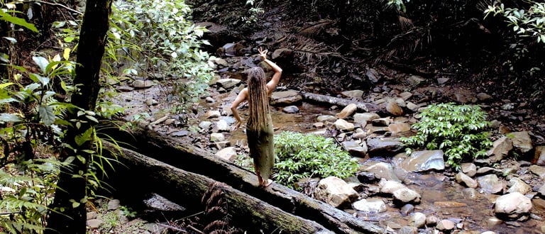 a woman with dreadlocks in the rainforest