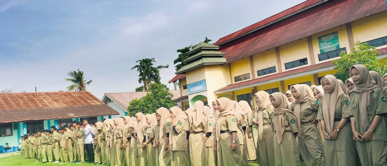 a group of people standing in line in front of a building SMK ASY-SYIFA Bekasi