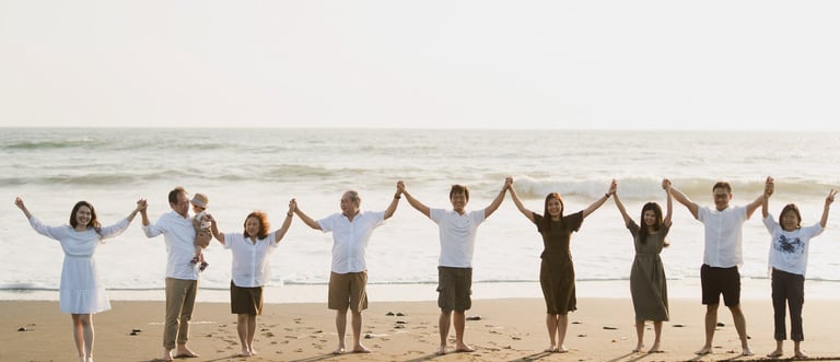 Large multi generation family standing together on Nyanyi Beach in Tabanan Bali during a sunset family photography session