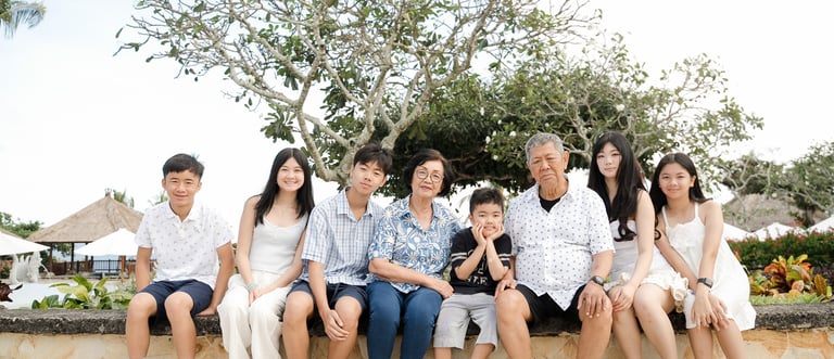 Multigenerational family sitting and sharing a relaxed moment during a lifestyle session at Ayana Resort Jimbaran Bali