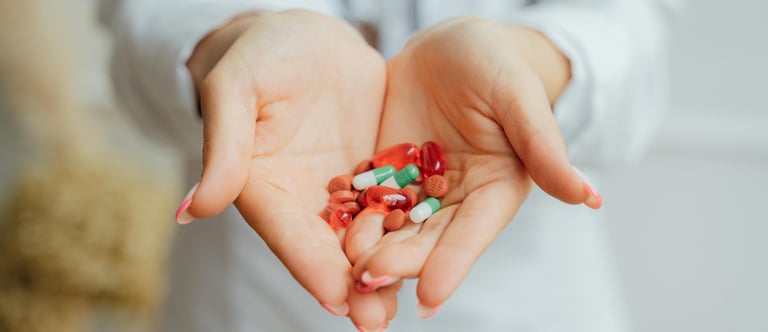 a woman holding a bunch of pills and pills