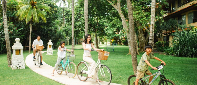 family cycling together during Westin Nusa Dua Bali photography session