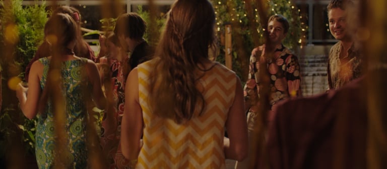 a group of people standing around a table