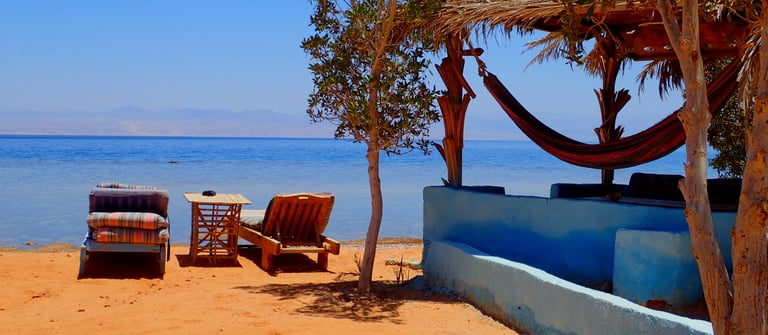 beachview with chaise lounge and bungalow in front of the sea Bedouin star Egypt