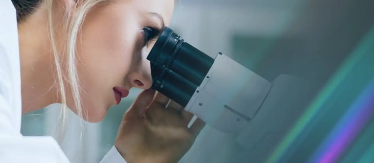 Health and biotech Investigator looking through a microscope