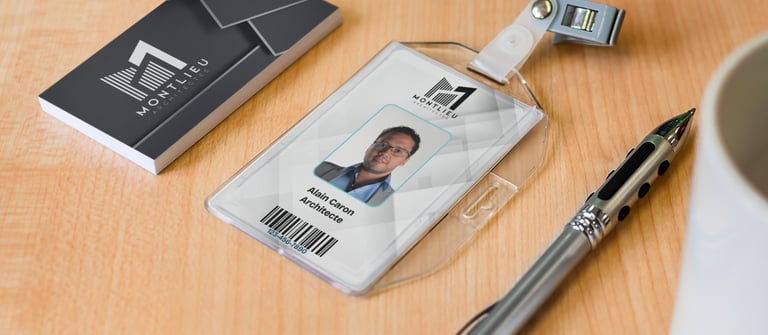 Professional architect employee identification badge and business cards on an office desk with a silver pen.