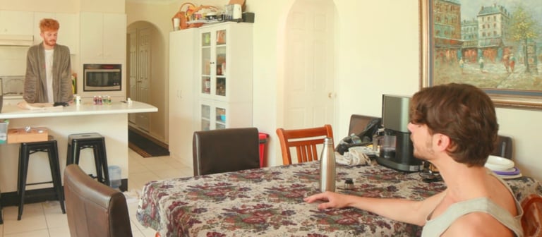 a man sitting at a table with a laptop computer