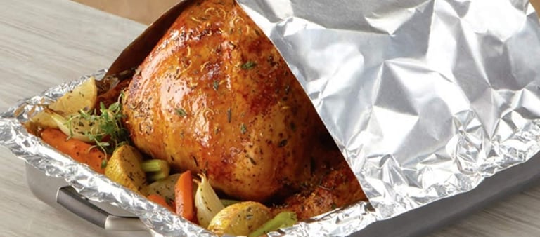 a turkey roasting turkey in foil