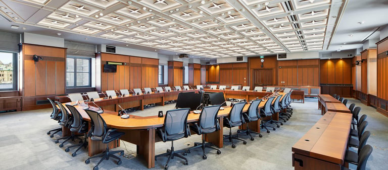 a conference room with a large wooden table and chairs