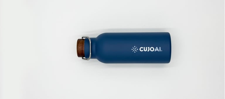 Reusable navy blue CUJOAI insulated water bottle with a wooden cork stopper on a white background.