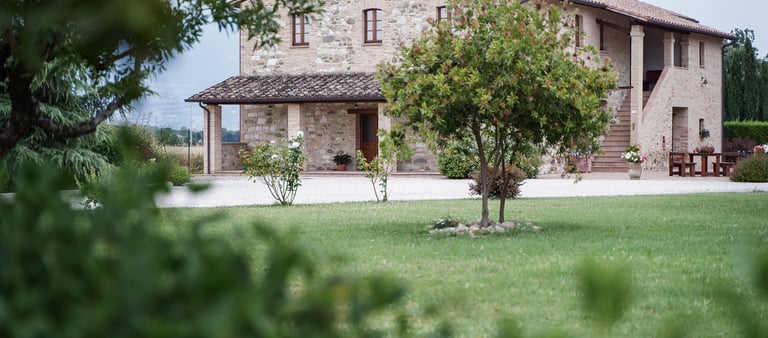 Veduta esterna del casale e giardino in una giornata di primavera
