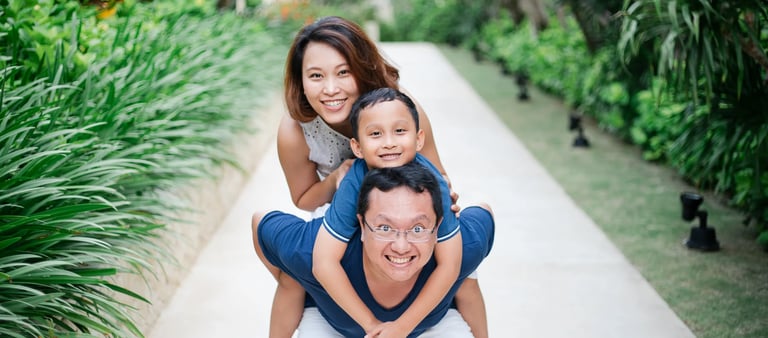 Happy family portrait on resort walkway at The Mulia Nusa Dua Bali