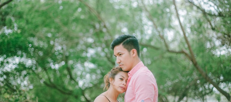Intimate couple embrace under trees during a photography session in Serangan Benoa Bali.