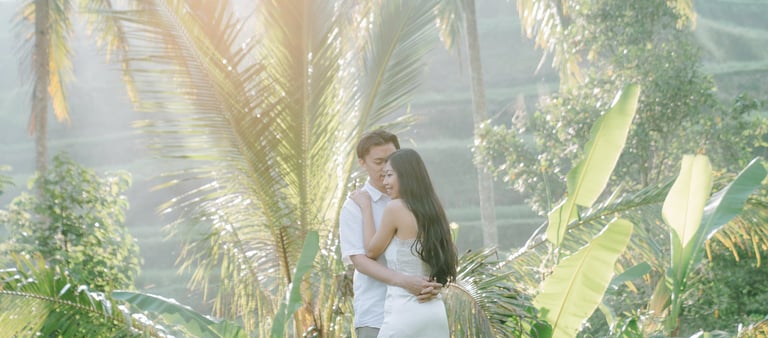 Romantic couple under palm trees during a sunrise photography session at Tegalalang Ubud Bali.