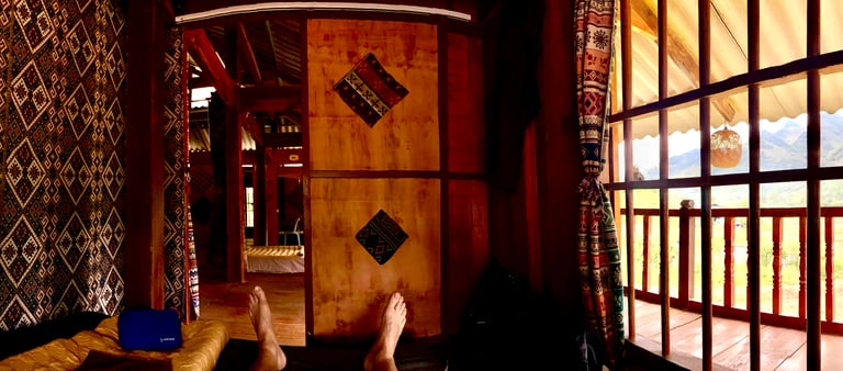 a person's feet on a bed in a homestay
