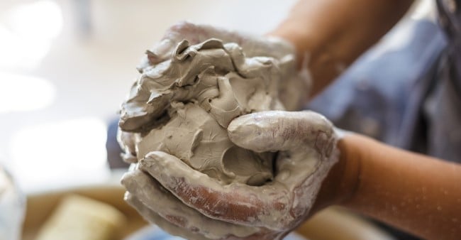 Uneven ball of clay in hands