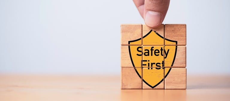 Building blocks with the graphic of a yellow shield saying "Safety First" on the front