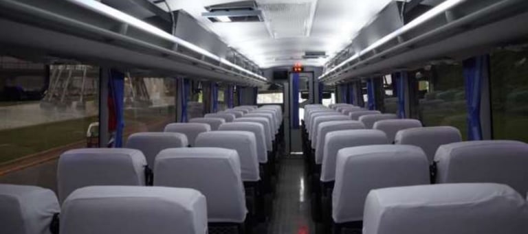 a bus with many seats and chairs in a bus