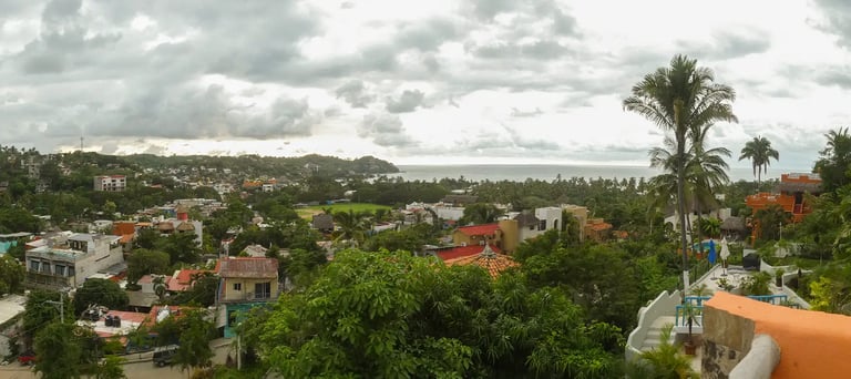 a pool with lounge chairs and a view of the ocean