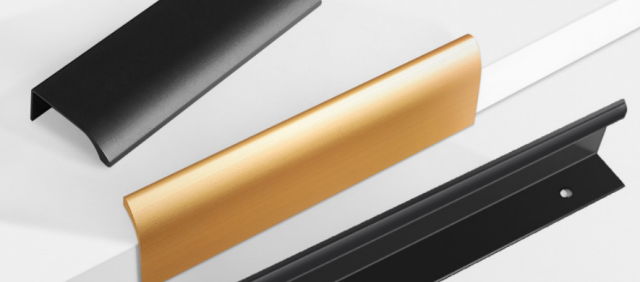 Hand installing a copper-toned aluminum alloy edge-mounted invisible handle on a white cabinet door