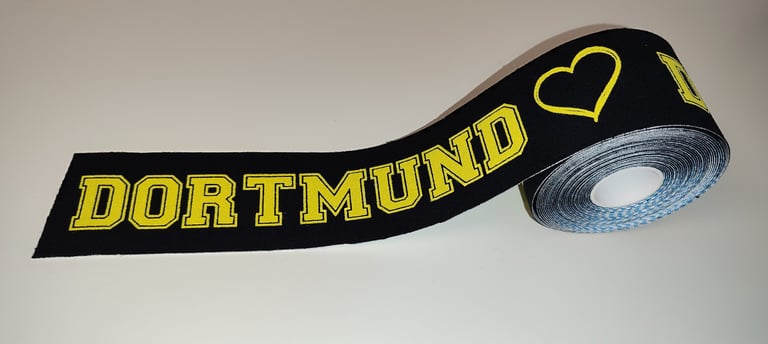 a black and yellow ribbon with a heart on it