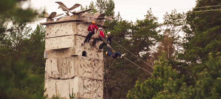 people climbing on a climbing tower