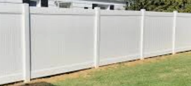 a white fenced in fenced in area with grass