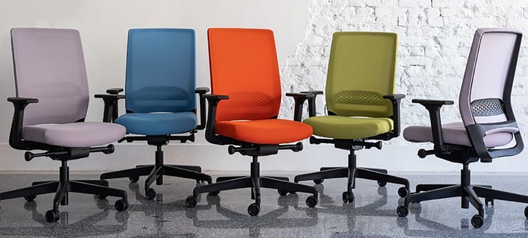 Five Sensit T129 clerical chairs in pastel purple, blue, orange, green, and side-view lilac, display