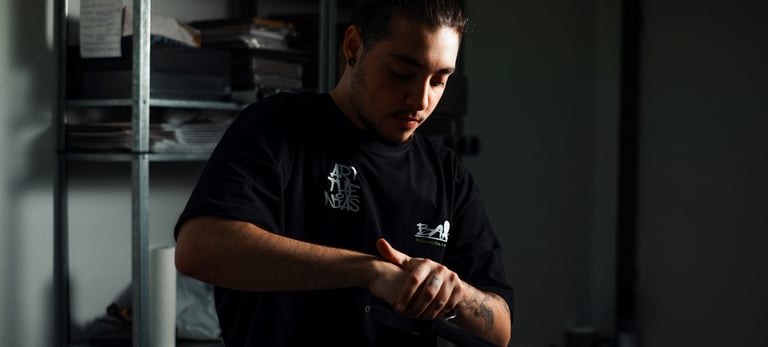 a man in a black shirt is holding a baseball bat