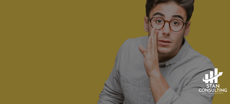 a man with glasses and a gray shirt