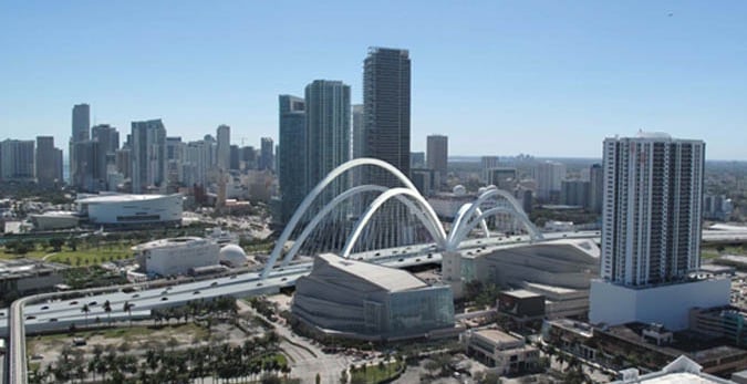 a city skyline view of a bridge spanning the city of downtown miami