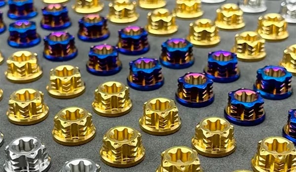 Collection of precision titanium fasteners in various grades and finishes including gold, blue, and 